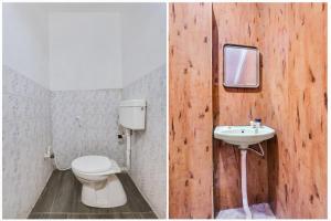 a bathroom with a toilet and a sink at Super Hotel O Chowrasta Near Congress Bhavan in Warangal