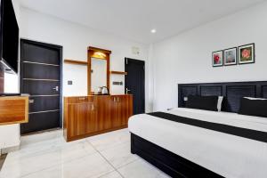 a bedroom with a large bed and a bathroom at Collection O Munnar in Munnar