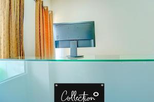 a computer monitor sitting on top of a desk at Super Collection O Kureepuzha Kollam in Kollam