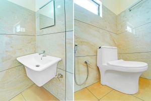 a bathroom with a toilet and a sink and a shower at Super Collection O Kureepuzha Kollam in Kollam +35 photos