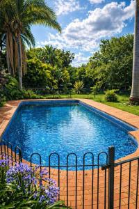 a swimming pool with a fence around it at 19 On Bay Noakes in Harare