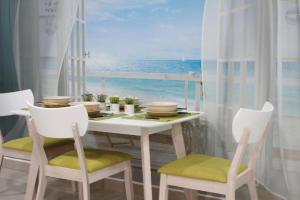 a dining room with a table with a view of the ocean at Majestic Cottage in Ipoh