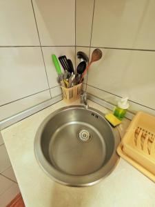 a stainless steel sink with utensils in a kitchen at Markov Konak in Divčibare +76 photos