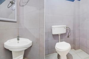 a bathroom with a toilet and a sink at Hotel O Garchuk Market Formerly Trendz Stay in Guwahati