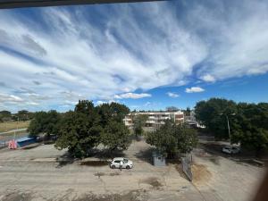 a car parked in a parking lot with trees at Caponero accommodation conference in Welkom +8 photos