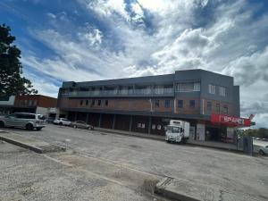 a parking lot in front of a building at Caponero accommodation conference in Welkom