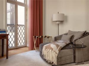 a living room with a couch and a window at Four Suites Copenhagen - Boutique Townhouse Suites in Copenhagen