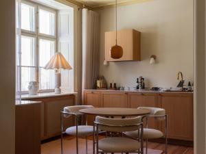 a kitchen with a table and chairs and a sink at Four Suites Copenhagen - Boutique Townhouse Suites in Copenhagen