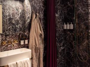 a bathroom with a sink and a shower at Four Suites Copenhagen - Boutique Townhouse Suites in Copenhagen +25 photos