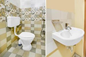 a bathroom with a toilet and a sink at Collection O Victoria Memorial Metro Station Formerly Shanthaa Residency in Surūrnagar