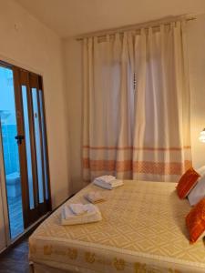 a bedroom with a bed with two towels on it at 4 stagioni in Villasimius