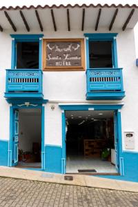 a blue and white building with a sign on it at Hotel Santa Laura in Jericó