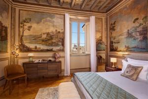 a bedroom with a bed and a painting on the wall at Palazzo Massimo Boutique Piazza Venezia in Rome