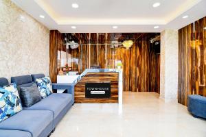 a living room with a couch and a table at Super Townhouse Rosedale Formerly Reliance Guest House in Kolkata