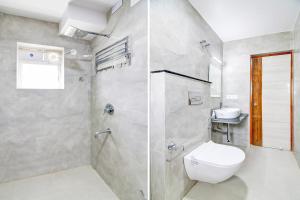 a bathroom with a shower with a toilet and a sink at Super Townhouse Rosedale Formerly Reliance Guest House in Kolkata +45 photos