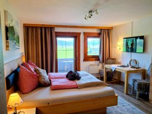 a bedroom with a bed with red pillows on it at Lampererhof in Sankt Johann in Tirol