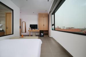 a white room with a large window and a table at Solla Hotel in Ninh Binh +25 photos