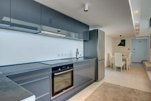 a kitchen with stainless steel appliances and a dining room at Beach Apartments in Ulcinj