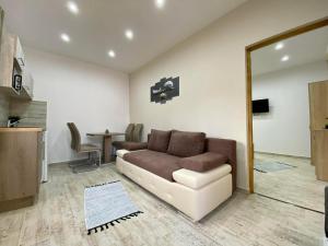 a living room with a couch and a table at Tündi Vendégház in Balatonlelle