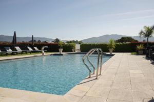 a swimming pool with a metal ladder in the middle at Casa d'Amares in Amares
