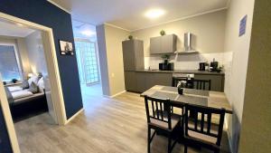 a kitchen and dining room with a table and chairs at Liro Apartments Düsseldorf in Düsseldorf +21 photos