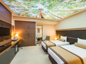a hotel room with two beds and a painting on the ceiling at Hotel Sky Nest Suites Near IGI Airport Delhi in New Delhi +36 photos