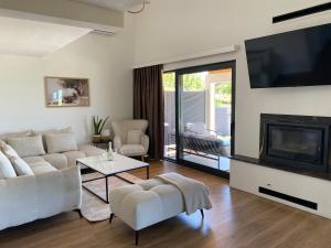 a living room with a couch and a fireplace at Villa Infinity View in Široki Brijeg