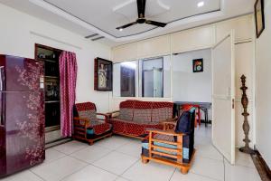 a living room with chairs and a ceiling fan at OYO Hotel O Benz Circle Vijayawada in Vijayawāda