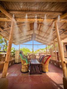 a porch with chairs and a table on a roof at VVIP Gajban Resort & Desert Stay, Bikaner in Bikaner