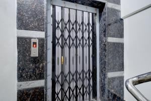 a metal door with a geometric design on a wall at Super Collection O Forum Mall Hyderabad Formerly Ruby Grand Inn in Kondapur