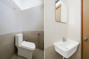 a bathroom with a sink and a toilet and a mirror at Super Collection O Forum Mall Hyderabad Formerly Ruby Grand Inn in Kondapur