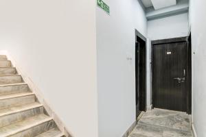 a stairway leading to a door in a building at Super Hotel O Narayana RN Tagore Hospital Formerly Lantern Guest House in Jādabpur