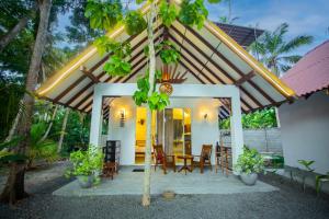 a house with a porch with a table and chairs at Ceylon Princes Villa in Ahangama