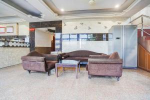 a living room with two couches and a table at Hotel O Jamalpur Ahmedabad Formerly Hotel Peace in Ahmedabad