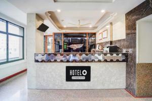 a nola store with a counter in a room at Hotel O Jamalpur Ahmedabad Formerly Hotel Peace in Ahmedabad +34 photos