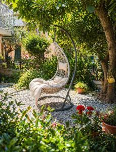 a chair sitting in the middle of a garden at L'isola felice in Cecina