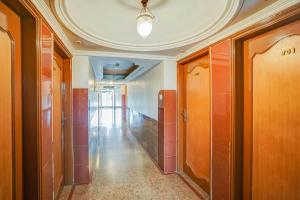 a hallway in a building with a ceiling and doors at Hotel O Jamalpur Ahmedabad Formerly Hotel Peace in Ahmedabad