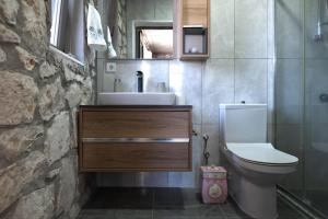 a bathroom with a sink and a toilet at Kösedere Stone Houses in Karaburun +34 photos