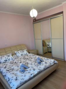 a bedroom with a large bed with blue pillows at Sofia villa in Elaiokhórion