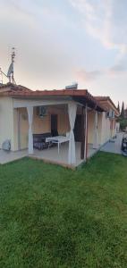 a house with a patio with a grass yard at Sofia villa in Elaiokhórion +12 photos