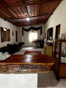 a living room with a wooden table in the middle at Chácara nosso pedacinho do céu in Domingos Martins