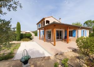a house in the middle of a garden at Villa les Mazes in Vallon-Pont-dʼArc