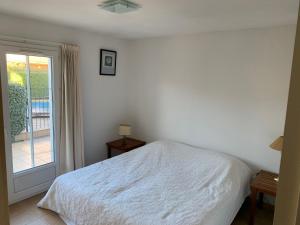 a bedroom with a white bed and a window at Villa les Mazes in Vallon-Pont-dʼArc +19 photos