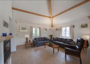 a living room with a couch and a table at Villa les Mazes in Vallon-Pont-dʼArc