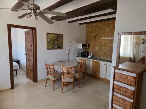 a kitchen with a table and chairs in a room at Apartamentos El Tosal 7E in Calpe