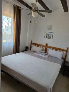 a bedroom with a bed and a ceiling fan at Apartamentos El Tosal 7E in Calpe +94 photos