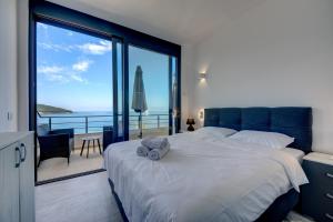 a bedroom with a large bed with a view of the ocean at Beach Apartments in Ulcinj