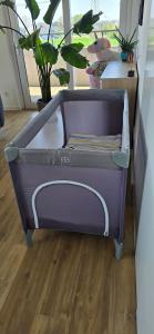 a purple toddler bed in a room with a window at Apartamenty Natura in Opole