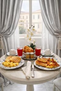 a table with two plates of food on it at Barberini Dream in Rome +84 photos