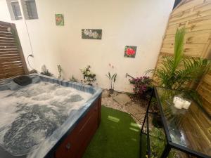 a jacuzzi tub in a backyard with plants at Le Corail - Résidence Terre et Truffes in Le Lamentin +31 photos